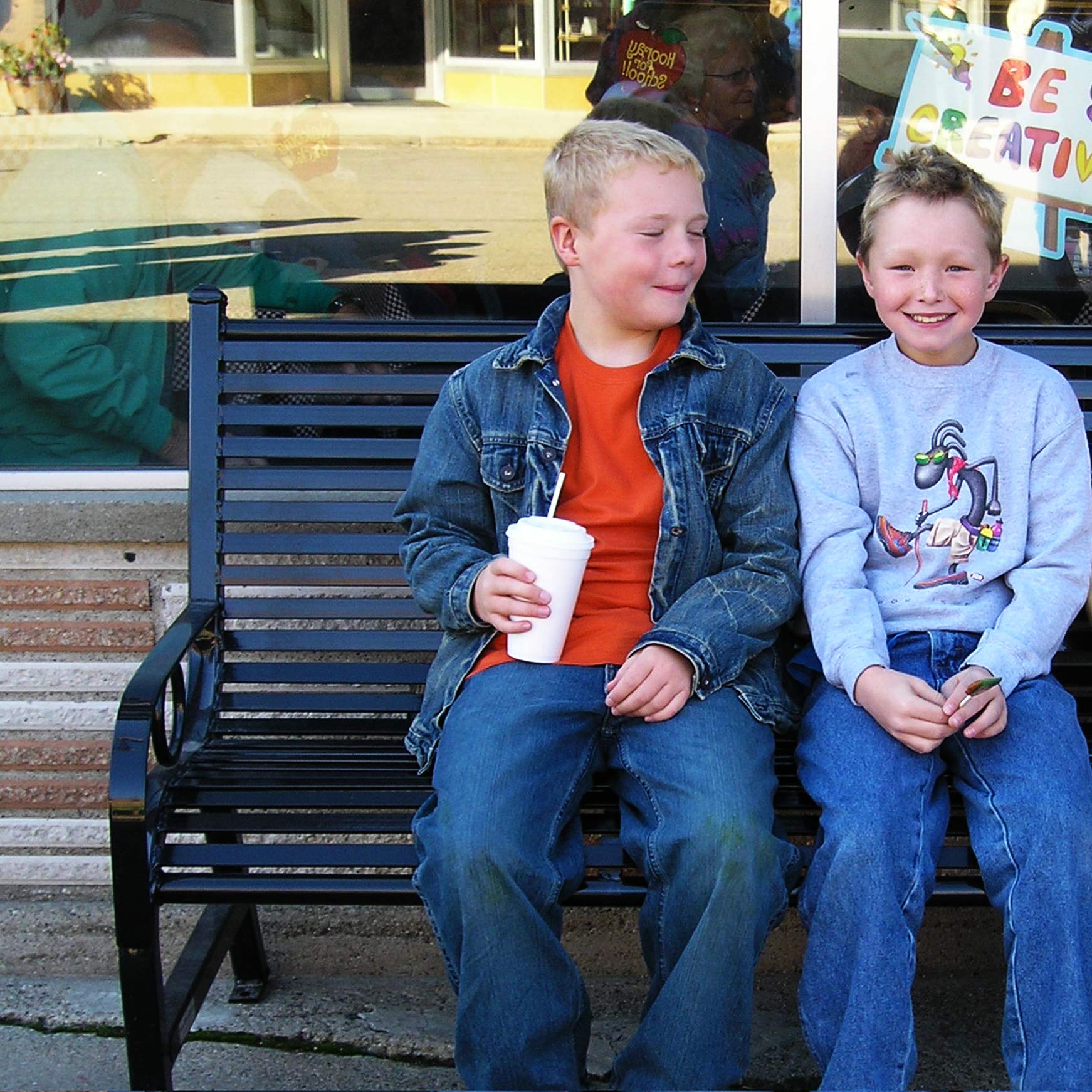 Friends spending time on a donated park bench from OCC Outdoors.